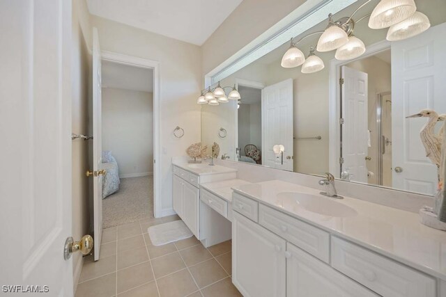 bathroom featuring tile patterned floors, an enclosed shower, and vanity