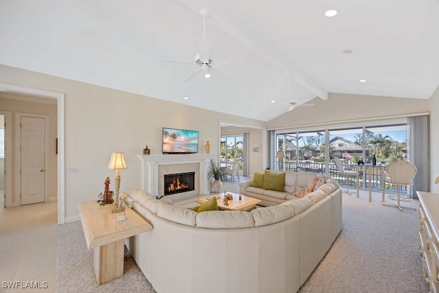 living room with vaulted ceiling with beams, light tile patterned floors, a healthy amount of sunlight, and ceiling fan