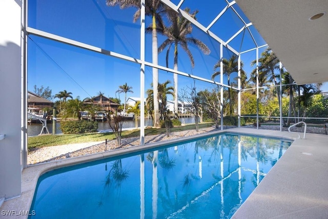 view of swimming pool featuring a water view, glass enclosure, and a patio area