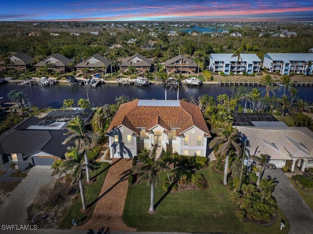 aerial view at dusk with a water view