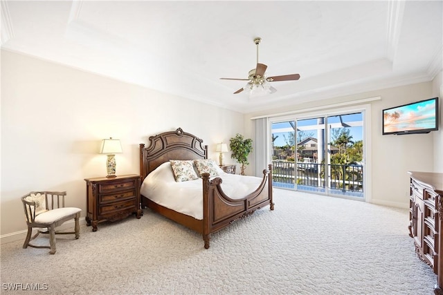 bedroom with light colored carpet, ornamental molding, a raised ceiling, ceiling fan, and access to exterior