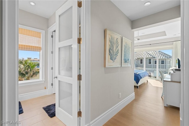 hallway with light hardwood / wood-style flooring