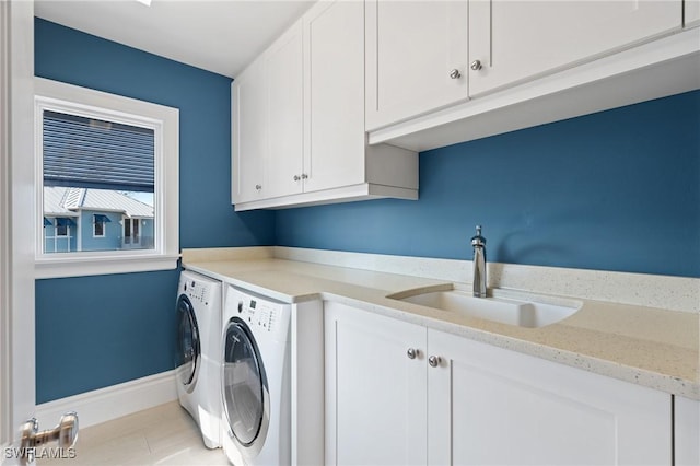 washroom with cabinets, sink, and washer and clothes dryer