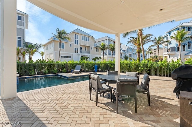 view of pool with grilling area and a patio area