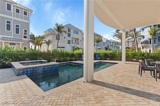 view of swimming pool featuring an in ground hot tub and a patio area