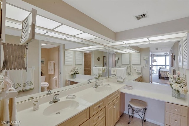 bathroom with vanity, tile patterned floors, and toilet