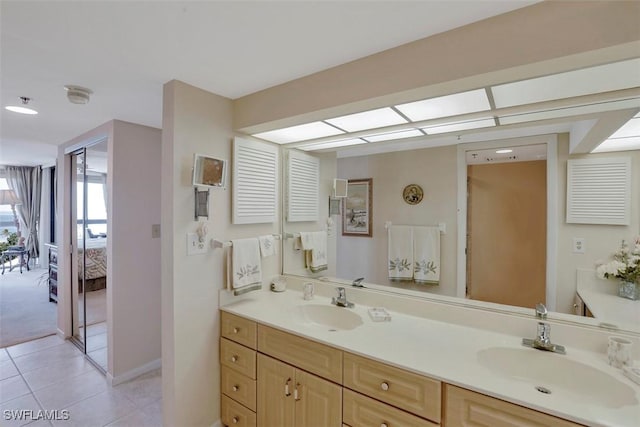 bathroom featuring tile patterned flooring and vanity