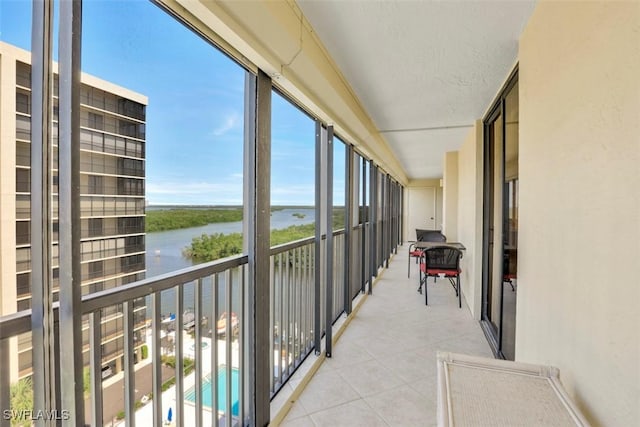 unfurnished sunroom with a water view