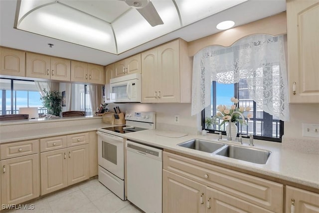 kitchen featuring white appliances, sink, and light tile patterned floors