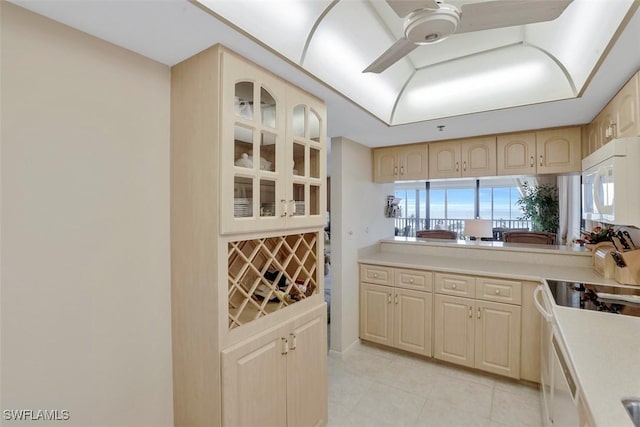 kitchen with ceiling fan, light brown cabinetry, electric range oven, and light tile patterned floors