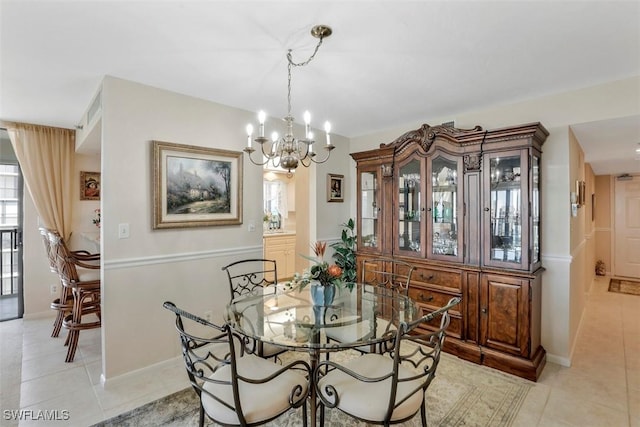 dining room with light tile patterned flooring and an inviting chandelier