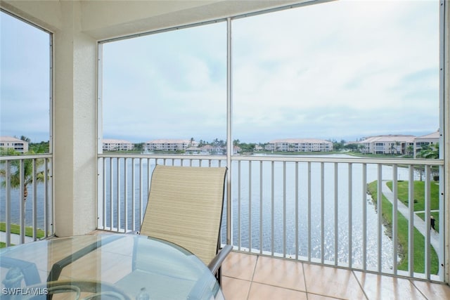 sunroom / solarium featuring a water view