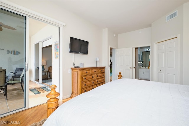 bedroom featuring a closet, connected bathroom, and hardwood / wood-style flooring