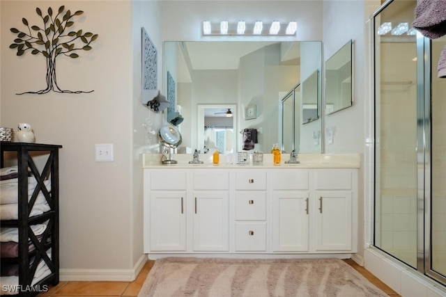 bathroom featuring vanity, tile patterned flooring, and a shower with door