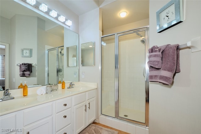 bathroom with tile patterned floors, an enclosed shower, and vanity