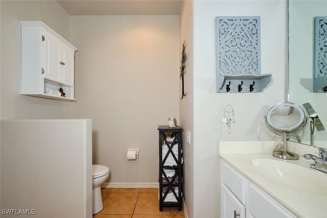 bathroom with tile patterned floors, vanity, and toilet