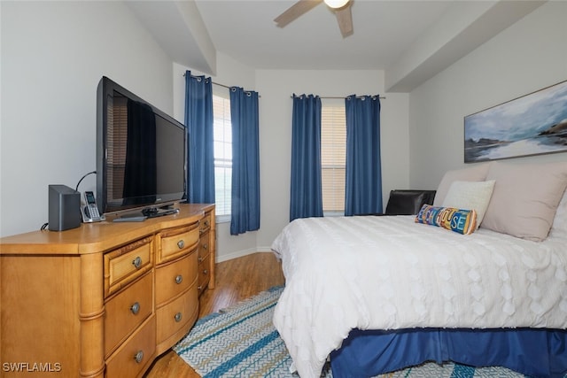 bedroom with ceiling fan and light hardwood / wood-style floors