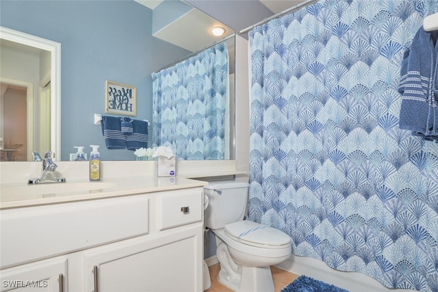 bathroom with toilet, vanity, tile patterned flooring, and walk in shower