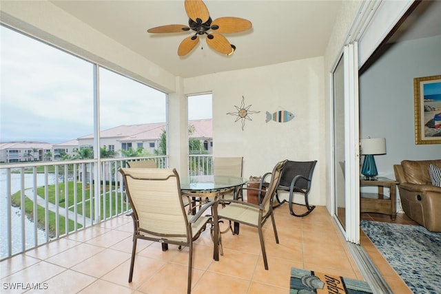 sunroom featuring ceiling fan