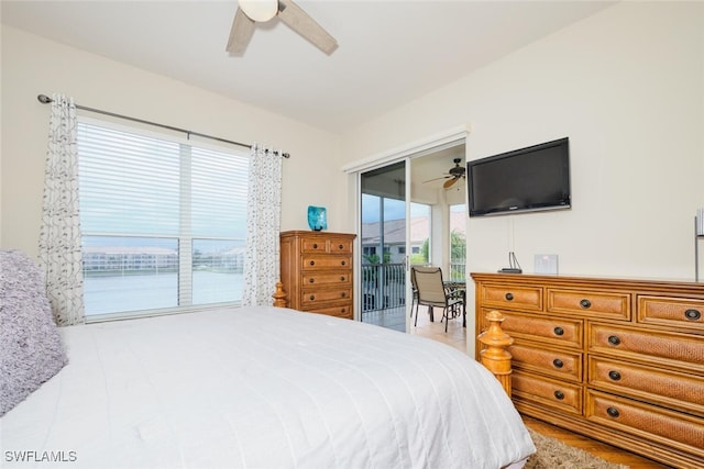 bedroom with ceiling fan, access to exterior, and multiple windows