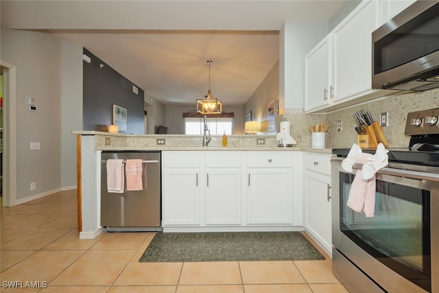 kitchen with tasteful backsplash, white cabinets, kitchen peninsula, and appliances with stainless steel finishes