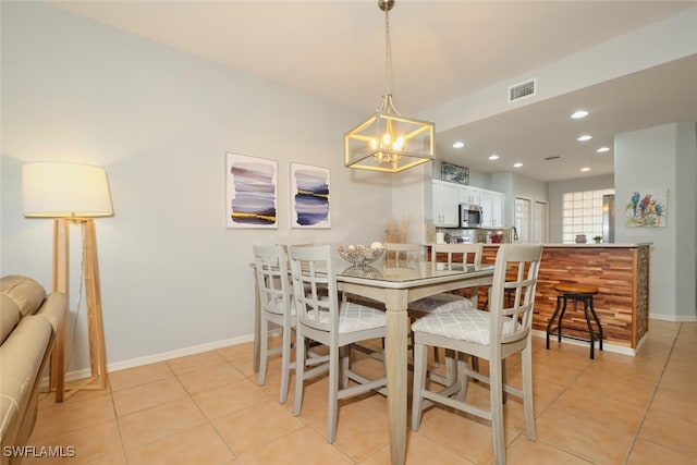 dining area with an inviting chandelier and light tile patterned floors