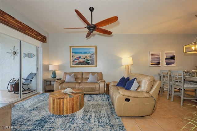 living room featuring light tile patterned floors and ceiling fan with notable chandelier