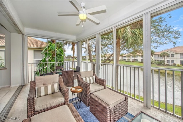 sunroom / solarium with a water view, ceiling fan, and plenty of natural light