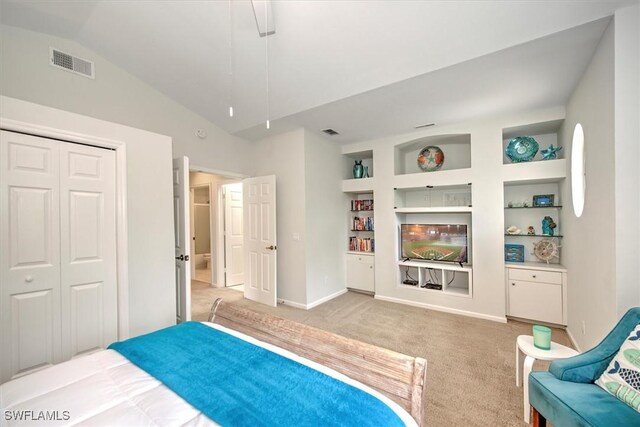 bedroom with light carpet, a closet, and lofted ceiling