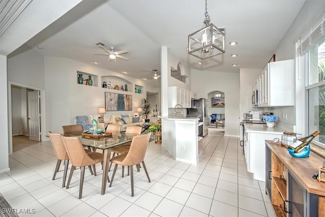 dining space with ceiling fan and light tile patterned floors