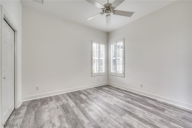 empty room with light hardwood / wood-style flooring and ceiling fan