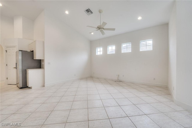 tiled empty room featuring high vaulted ceiling and ceiling fan