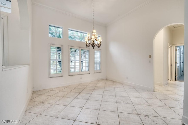 unfurnished room featuring crown molding, a towering ceiling, light tile patterned flooring, and a notable chandelier