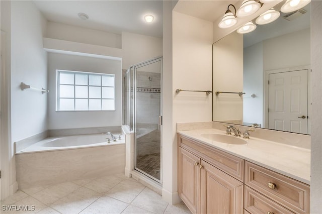 bathroom featuring vanity, independent shower and bath, and tile patterned flooring