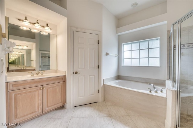 bathroom featuring vanity, tile patterned flooring, and separate shower and tub