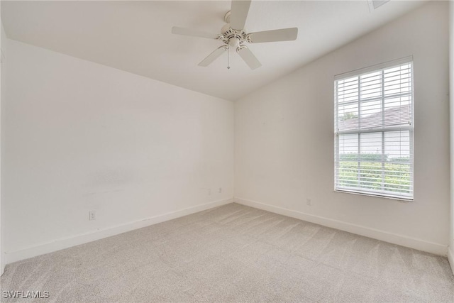 carpeted empty room featuring ceiling fan and lofted ceiling