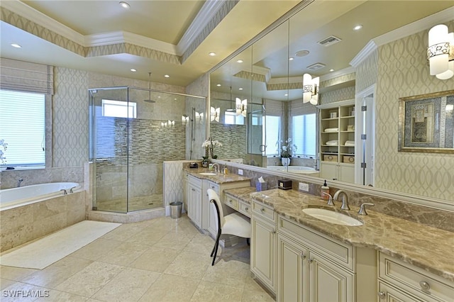 bathroom with crown molding, a healthy amount of sunlight, and a tray ceiling