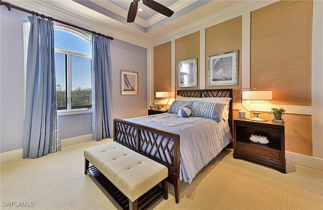 bedroom with crown molding, multiple windows, a tray ceiling, and carpet