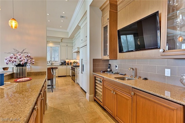 kitchen with crown molding, decorative light fixtures, light stone countertops, and stainless steel stove