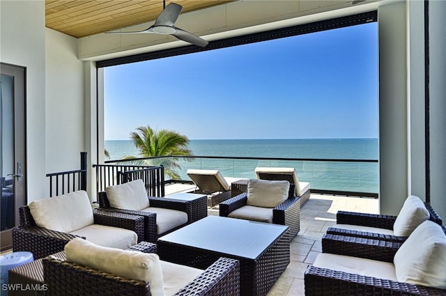 view of patio with a water view, ceiling fan, an outdoor hangout area, and a balcony