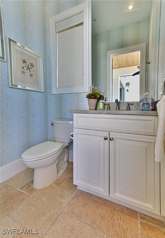 bathroom featuring vanity and toilet