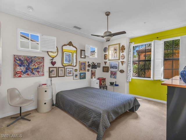 bedroom with ceiling fan, carpet, and crown molding