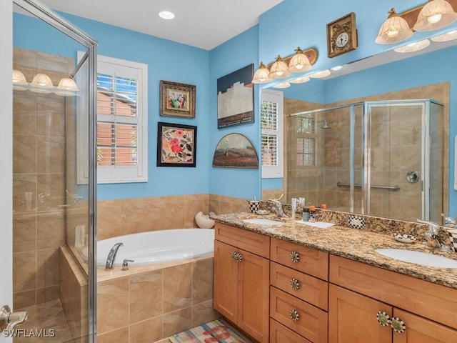 bathroom featuring independent shower and bath and vanity