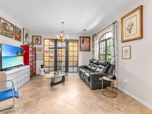 sitting room featuring an inviting chandelier, light tile patterned flooring, and french doors