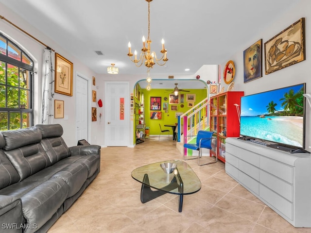 living room with light tile patterned floors and a chandelier