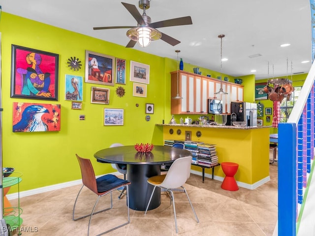 dining space with ceiling fan and light tile patterned floors