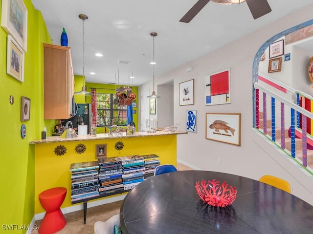 tiled dining area with ceiling fan