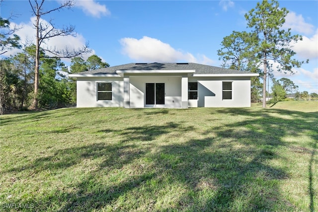 rear view of house with a yard