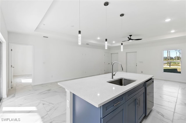 kitchen featuring ceiling fan, a tray ceiling, decorative light fixtures, stainless steel dishwasher, and sink