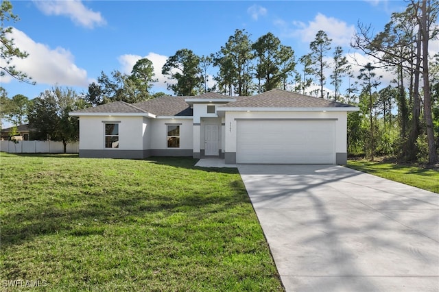 view of front of home with a front yard and a garage